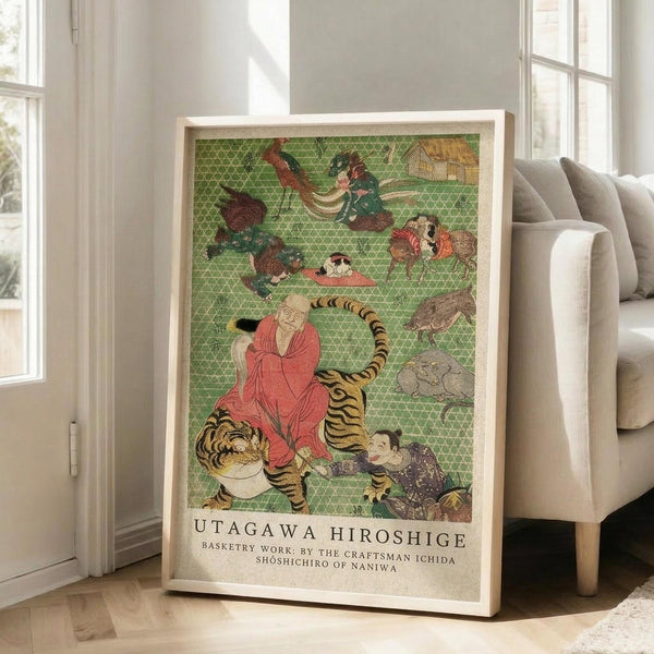 May include: Framed Japanese woodblock print featuring a monk in red robes sitting on a striped tiger, surrounded by various animals and mythological creatures on a green geometric patterned background. The print is displayed in a light wood frame leaning against a white wall next to a beige sofa in a bright, modern living room with large windows and natural lighting.