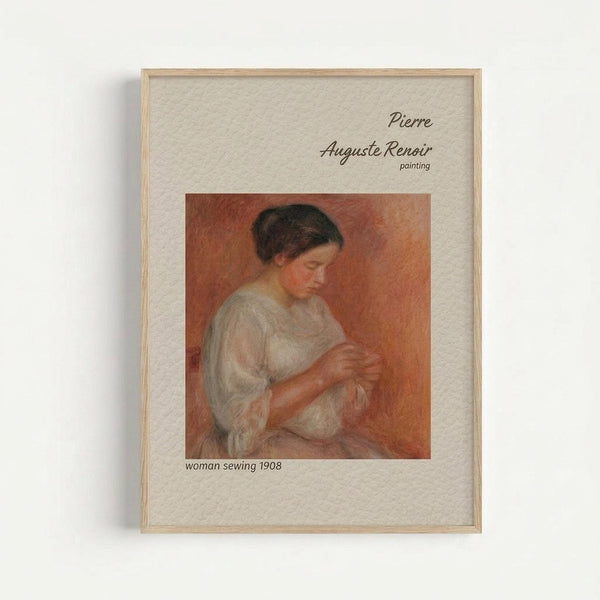 A framed art print featuring a Pierre-Auguste Renoir painting of a woman in a white blouse sewing, set against warm orange tones. The image shows soft, impressionistic brushwork typical of Renoir's style. Text identifies the artist and artwork details on cream-colored matting within a light wood frame, mounted on a white wall.