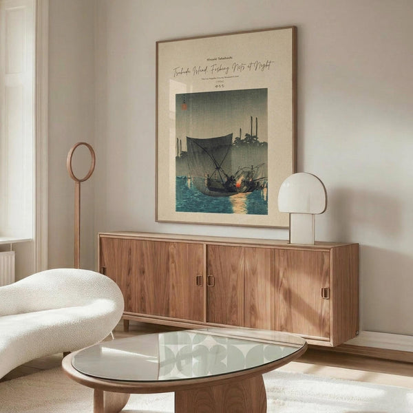 May include: Japanese woodblock print poster in wooden frame showing fishing boats at twilight, displayed above walnut credenza in modern living room with cream walls, white sculptural chair, glass coffee table, and minimalist decor
