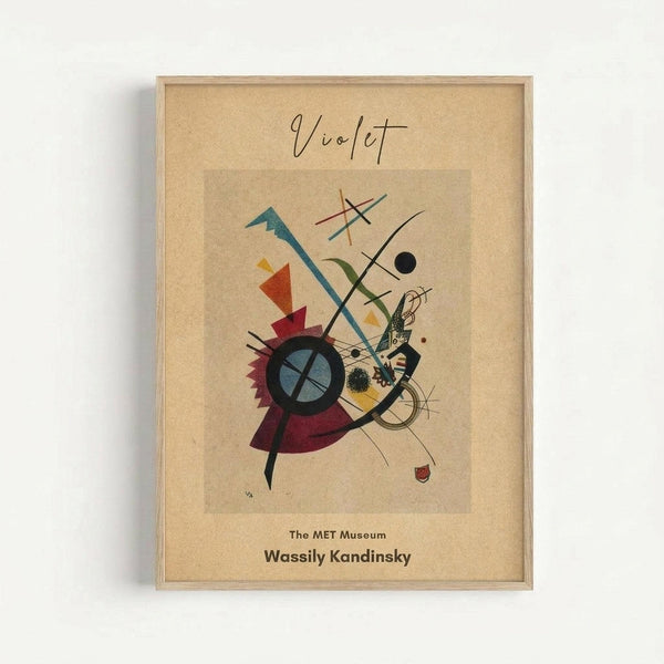 Framed abstract art print featuring geometric shapes in vibrant colors including teal, red, yellow, and purple arranged around a central black circle with blue interior. The composition includes intersecting lines, triangular forms, and organic curved elements against a cream background. Text at top reads "Violet" in handwritten style, with "The MET Museum" and "Wassily Kandinsky" printed below the artwork. Light wood frame mounted on white wall.