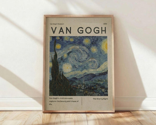 May include: Framed museum-style poster featuring Van Gogh's Starry Night painting with swirling blue sky and yellow stars, displayed on light wooden floor against white wall with natural sunlight shadows. Beige background with black text reading "VAN GOGH" and "1889" at top, artwork description and title at bottom. Natural wood frame with visible grain texture.