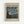 May include: Framed museum-style poster featuring Van Gogh's The Starry Night painting with swirling blue sky, yellow stars, and dark cypress tree. Light wood frame on white wall background. Beige poster with black text reading "VAN GOGH" at top, "Van Gogh Museum 1889" in corner, and descriptive text below the artwork about vivid canvases capturing beauty and chaos of life.