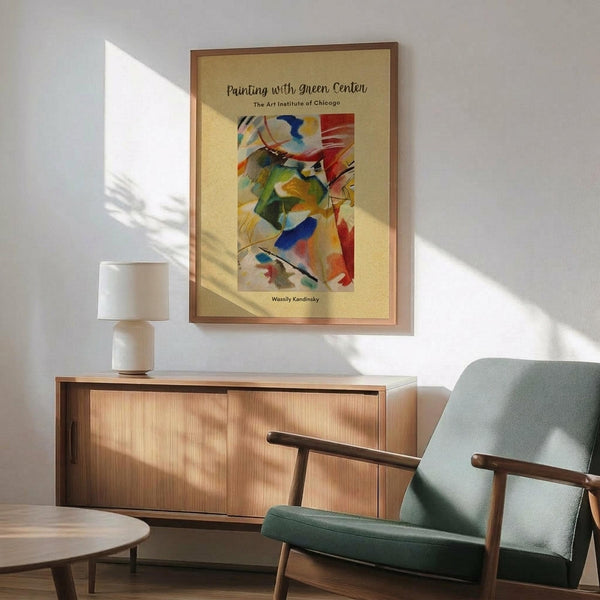 May include: Framed abstract art poster featuring vibrant brushstrokes in blues, greens, reds, and yellows on cream background, displayed above mid-century modern wooden sideboard with white ceramic lamp, next to sage green upholstered armchair with wooden frame in sunlit room with white walls
