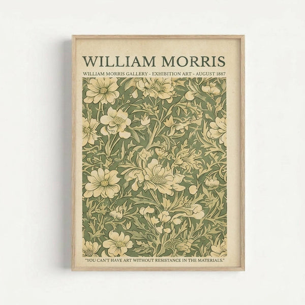 May include: Framed vintage-style poster featuring William Morris floral pattern in muted green and cream tones, displaying densely packed botanical design with large blooms, leaves, and intricate vine details. Light wood frame against white wall, casting subtle shadow. Text at top reads exhibition details from August 1887, with quote at bottom about art and materials.