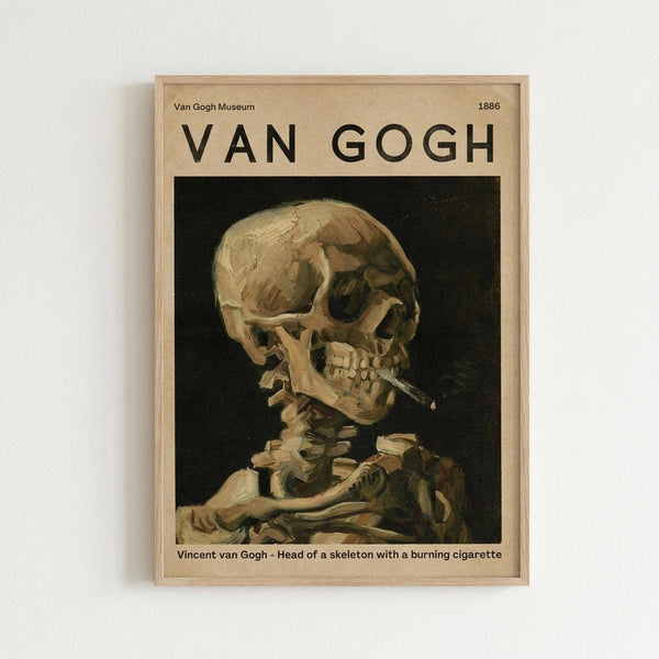 May include: Framed museum-style poster featuring Van Gogh's painting of a human skull with cigarette against dark background, displayed on white wall. Light wood frame surrounds cream-colored poster with bold black "VAN GOGH" text at top and artwork details below the skeletal portrait painted in warm yellows and browns.