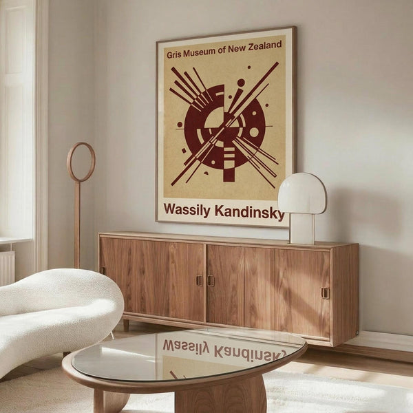 May include: Framed museum poster featuring abstract geometric design in burgundy on cream background, displayed above mid-century walnut credenza in modern living room with white curved chair, glass coffee table, and minimalist decor