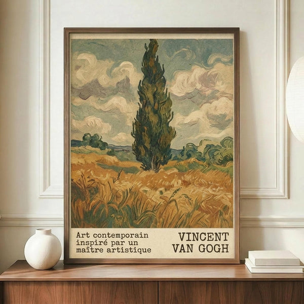 May include: Framed Van Gogh-style landscape poster showing tall dark cypress tree against swirling cloudy sky, golden wheat field in foreground, displayed on wooden sideboard beside white ceramic vase and books in elegant room with white paneled walls and warm lighting.