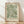 May include: Framed botanical art print featuring flowing green and cream leaf patterns in William Morris style, displayed in light wood frame against white textured wall. Soft natural lighting creates diagonal shadows across wooden floor. The decorative foliage design shows curving acanthus leaves in muted sage and ivory tones on vintage-style background.