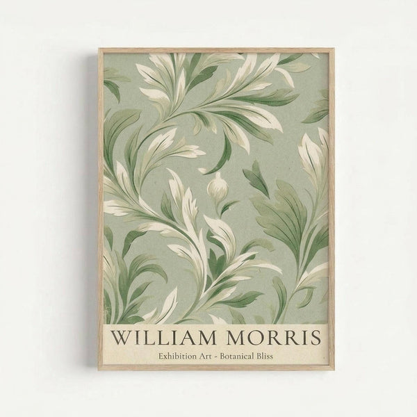 Framed botanical art print with flowing green and cream foliage pattern on sage background, displayed in natural wood frame against white wall. Features elegant swirling leaves and stems in vintage Arts and Crafts style with William Morris text at bottom.