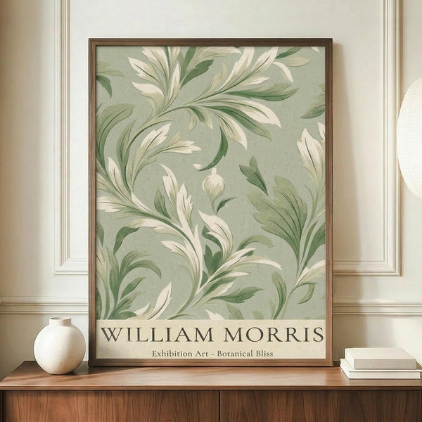 May include: Framed botanical poster with flowing green and cream foliage pattern on sage background, displayed on wooden sideboard next to white ceramic vase and stacked books. The artwork features swirling leaf motifs in William Morris style with text at bottom. Warm lighting illuminates the cream-colored room with decorative wall molding.