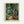 May include: Framed art print displaying Van Gogh's swirling cypress trees in rich greens, blues, and golden yellows with characteristic thick brushstrokes and flowing movement. The print sits in a light wood frame against a white wall, showing the dynamic, undulating forms of tall trees with textured foliage rendered in Van Gogh's distinctive Post-Impressionist style.
