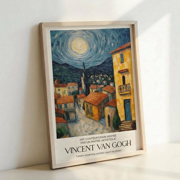 May include: Framed poster print leaning against white wall showing Van Gogh-style painting of Mediterranean village with swirling night sky, bright moon, terracotta rooftops, and yellow buildings. Features French text and artist attribution below artwork. Light wood frame with white matting, positioned on white surface with soft natural lighting creating gentle shadows.