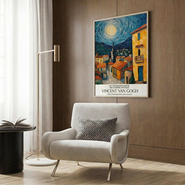May include: Vincent van Gogh inspired poster print hanging on wood-paneled wall above beige upholstered armchair with geometric pillow. Artwork shows swirling night sky with bright moon over Mediterranean village with orange rooftops, church spire, and yellow buildings. Modern living room setting with brass floor lamp, black side table with open book, and light wood flooring.