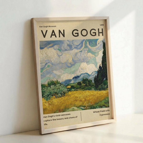 A framed poster featuring Van Gogh's Wheat Field with Cypresses painting, displayed in a light wooden frame against a white wall. The artwork shows swirling blue and white clouds above a golden wheat field with dark green cypress trees. Text reads "VAN GOGH" at the top and includes museum-style details about the 1889 painting. The frame casts a subtle shadow on the minimalist white background.