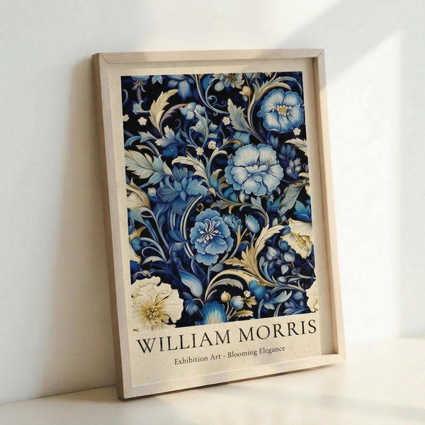 May include: Framed poster with intricate blue and cream floral pattern featuring ornate blooming flowers and decorative foliage on dark background, displayed in light wooden frame against white wall. Art print shows Victorian-style botanical design with flowing curves and detailed petals in shades of blue, navy, and ivory.