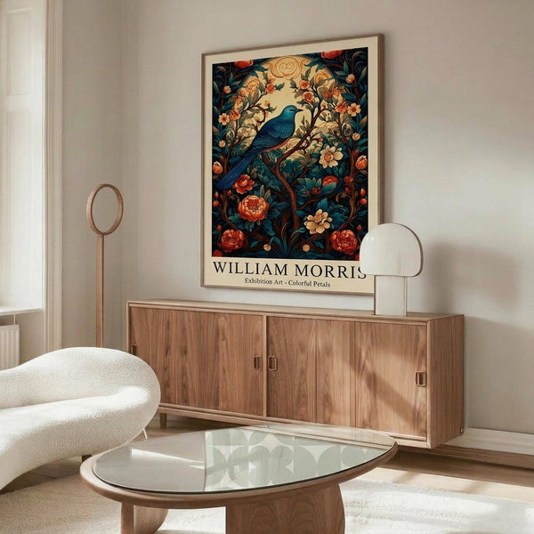 May include: Framed poster featuring a blue bird perched among ornate floral patterns with red roses and cream flowers on dark teal background, displayed above mid-century walnut credenza in minimalist living room with white upholstered chair, glass oval coffee table, and modern floor lamp