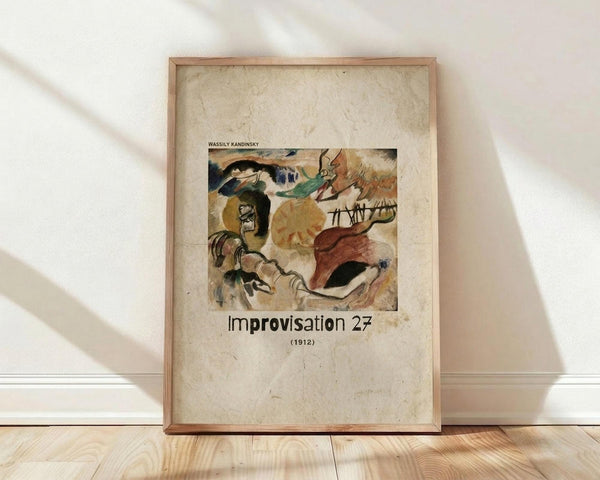 May include: A framed art print leaning against a white wall on light wooden flooring. The poster features Wassily Kandinsky's abstract watercolor painting from 1912 with flowing organic shapes in green, brown, orange and black tones. The artwork is displayed on aged beige paper background with "Improvisation 27" and "(1912)" text below. Natural light creates soft shadows across the scene. The thin wooden frame has a natural finish.
