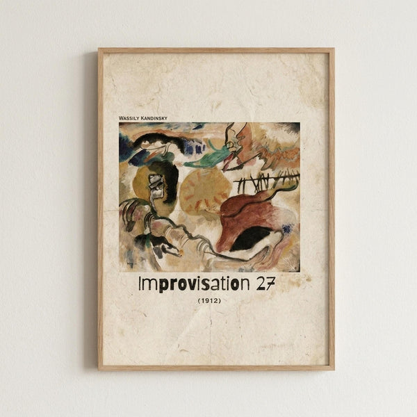 May include: Framed art print mounted on white textured wall showing Kandinsky's abstract expressionist painting with flowing organic forms in earth tones of brown, green, yellow and red, plus black linear elements. Natural wood frame surrounds cream-colored mat with artwork title and date below the image.