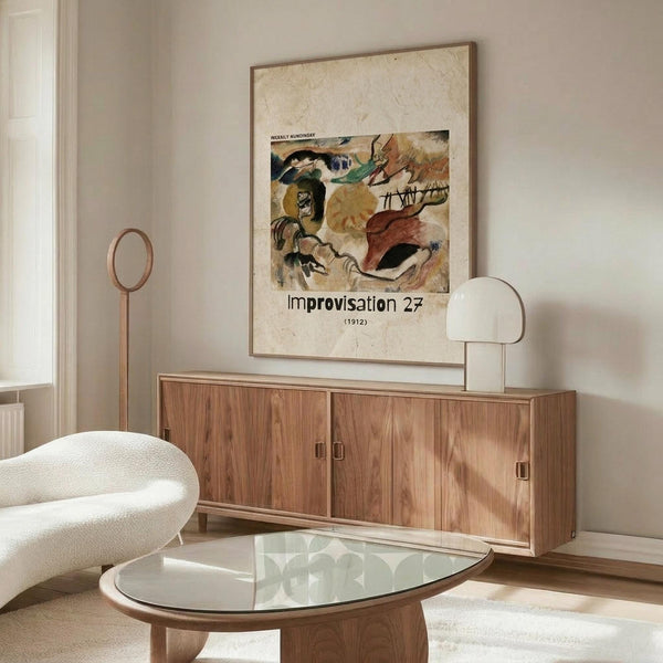 May include: Abstract expressionist artwork poster in wooden frame hanging above walnut credenza in modern living room. Colorful abstract painting features flowing organic shapes in earth tones - browns, oranges, greens, and blacks with dynamic brushstrokes. Room styled with cream upholstered chair, glass oval coffee table, and white sculptural table lamp on sideboard.