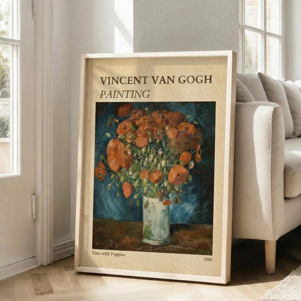 May include: Framed poster print of Van Gogh's orange poppies in white vase painting displayed on light wooden floor beside beige upholstered chair in bright white room with large windows. The vintage-style poster features cream colored border with dark text and shows the 1886 floral still life artwork with vibrant orange blooms against blue background.
