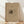 May include: Framed art print featuring an abstract Kandinsky drawing with dark ink marks and flowing lines on beige paper background, displayed in light wood frame leaning against white wall on natural wood flooring with soft window light creating diagonal shadows across the scene.