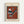 Framed abstract art print featuring geometric shapes in rust orange, teal, black, white and gray. The composition includes striped triangles, circles, and angular forms arranged on a burnt orange background with teal border. Displayed in light wood frame with cream matting against white wall. Text reads "Goris Museum of New Zealand" and "Wassily Kandinsky" in modern typography.