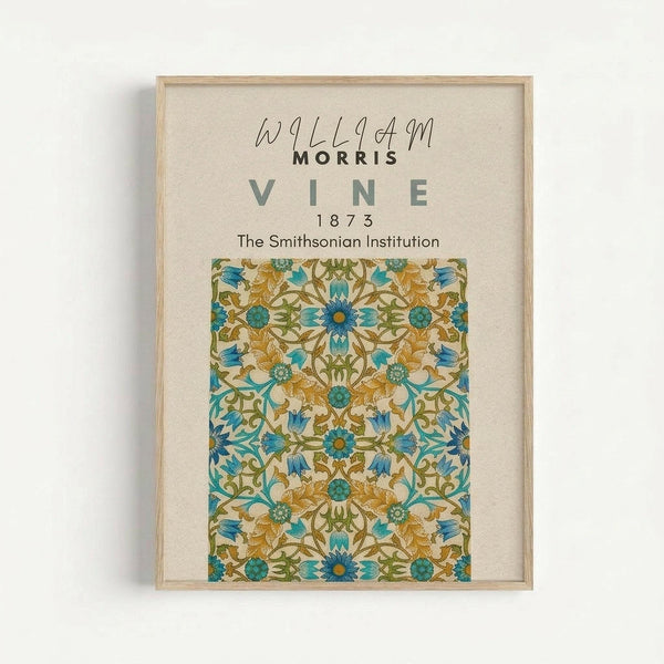Framed botanical art print featuring an intricate William Morris vine pattern from 1873 in teal, golden yellow, and green colors. The symmetrical floral design shows repeating motifs of stylized flowers, leaves, and vines on a cream background. Displayed in a light wood frame with cream matting, mounted on a white wall. The print includes attribution text to The Smithsonian Institution above the decorative pattern.