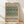 May include: Framed poster print with green and cream botanical tulip pattern from 1875, displayed in light wood frame against white wall on wooden floor. Vintage William Morris floral design with intricate leaves and blooms in sage green tones on cream background. Museum-style art print with text header and attribution.