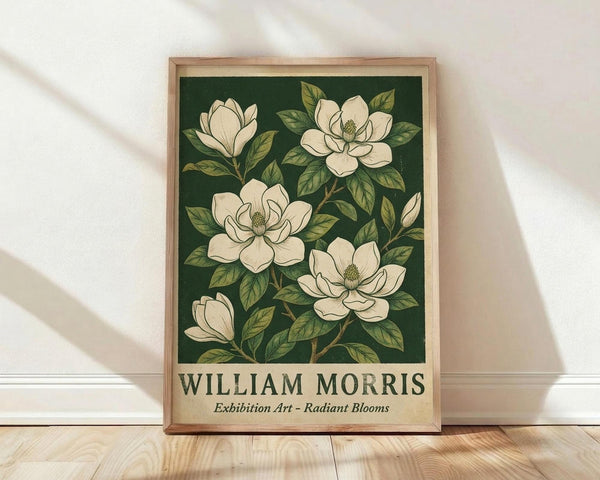 May include: Framed botanical poster with cream magnolia flowers and green leaves on dark forest green background, displayed in light wood frame against white textured wall on wooden floor with natural window light creating soft shadows