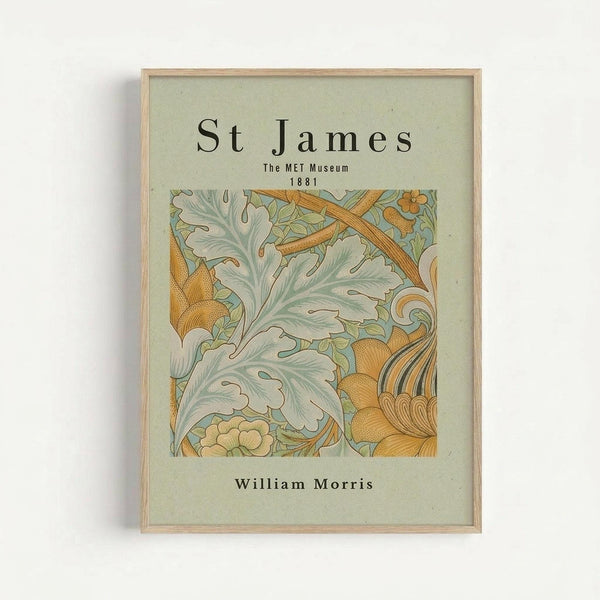 Framed vintage botanical art print featuring ornate acanthus leaves and flowing decorative elements in sage green, golden yellow, and cream tones. The William Morris-style design is matted in light green paper within a natural wood frame, displayed against a white wall. Text reads "St James The MET Museum 1881" above the artwork and "William Morris" below.