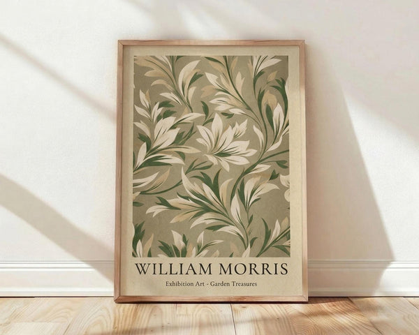 May include: Framed botanical art print leaning against white textured wall on light wooden floor. Features flowing green and cream foliage pattern in vintage Arts and Crafts style. Natural wood frame with warm lighting casting diagonal shadows across the scene. Print shows swirling leaves and organic forms in muted earth tones.