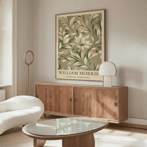 May include: Framed botanical art print with green and cream leaf pattern hanging above walnut credenza in minimalist living room. White upholstered chair and glass-top coffee table visible. Warm natural lighting creates soft shadows on beige wall.