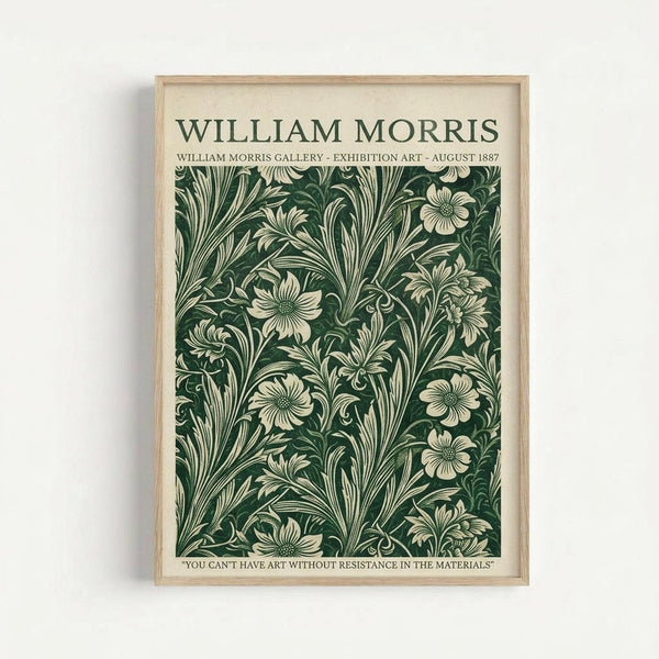 Vintage-style poster with cream background featuring William Morris text at top and intricate dark green floral pattern with cream colored flowers and flowing leaves. Quote at bottom reads "You can't have art without resistance in the materials." Natural wood frame against white wall background.