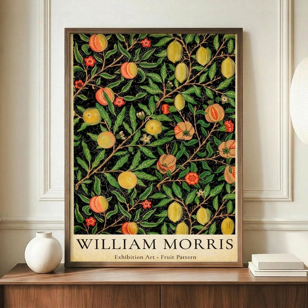 May include: Framed botanical art print featuring intricate fruit and floral pattern with yellow citrus, orange peaches, red berries, and green foliage on black background, displayed on wooden sideboard beside white ceramic vase and books in elegant room with cream walls and white molding.