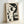 May include: Framed abstract geometric artwork featuring a stylized woman's profile in black and cream tones, displayed in light wood frame leaning against white wall. The minimalist composition uses curved and angular shapes, circles, and lines to create the portrait in a modern artistic style.