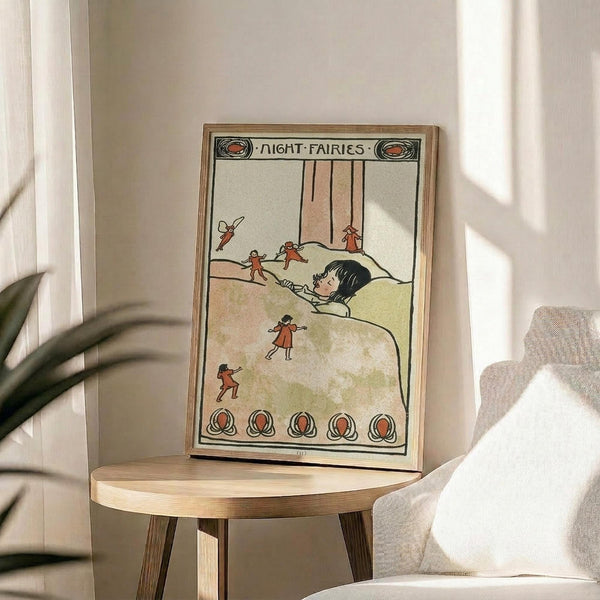 May include: Vintage children's book illustration in wooden frame showing a sleeping child in bed surrounded by small red-dressed fairies. The artwork features muted earth tones with decorative border elements and "Night Fairies" text at top. Frame sits on round wooden side table next to beige upholstered chair with green plant visible in soft natural lighting.