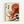 Japanese woodblock print style artwork featuring a large red octopus with flowing tentacles emerging from ocean waves. The octopus dominates the upper portion against a red sun, while stylized blue and white waves crash below in the manner of classic ukiyo-e prints. Black Japanese characters appear on the left side of the cream-colored background. The artwork is displayed in a thin wooden frame against a white wall.