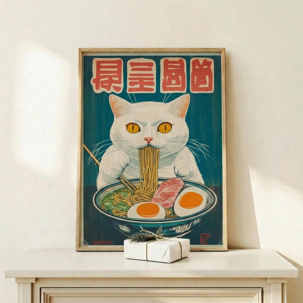 May include: Framed poster featuring a white cat with yellow eyes eating ramen noodles from a blue bowl, with red Japanese characters above on teal background. Wood frame displayed on light wooden shelf next to small white wrapped gift. Vintage-style illustration with detailed noodles, soft-boiled eggs, and meat toppings.