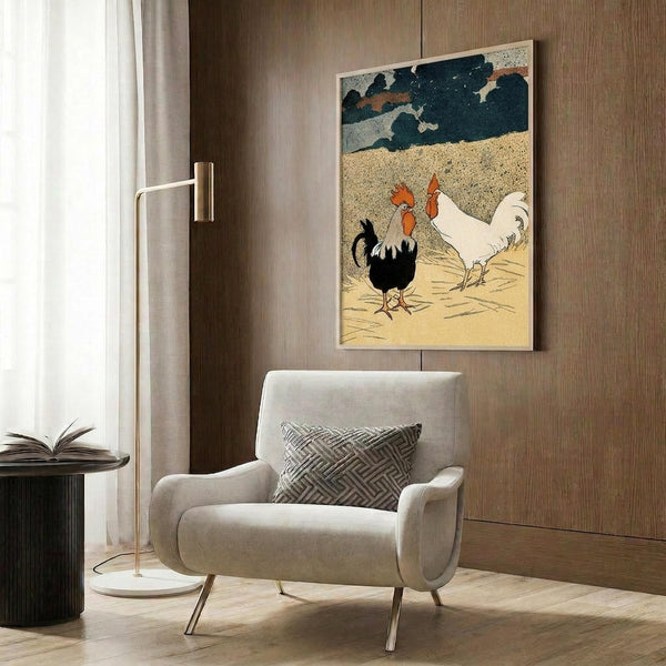 May include: Framed vintage-style poster featuring two roosters - one black with red comb and one white - against beige ground with dark blue cloudy sky. Print displayed on wood-paneled wall above cream upholstered armchair with geometric pillow. Modern reading nook setting with brass floor lamp and dark side table with open book.