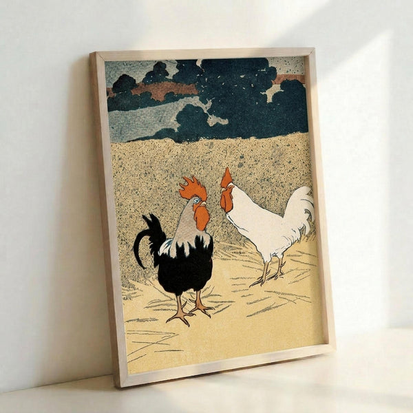May include: Framed vintage-style poster print leaning against white wall showing two roosters - one black with white tail feathers, one white with red comb and wattles - standing on sandy ground beneath dramatic cloudy sky in muted earth tones and dark blues. Light wood frame surrounds the textured artwork with crosshatched illustration style reminiscent of mid-century printmaking.