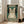 May include: Framed poster featuring a tabby cat wearing black headphones on a teal distressed background with cream text reading "Music Because Murder Is Wrong" and musical note graphics. The vintage-style print is displayed in a bright living room with white walls, large windows, and a beige sofa visible in the background.