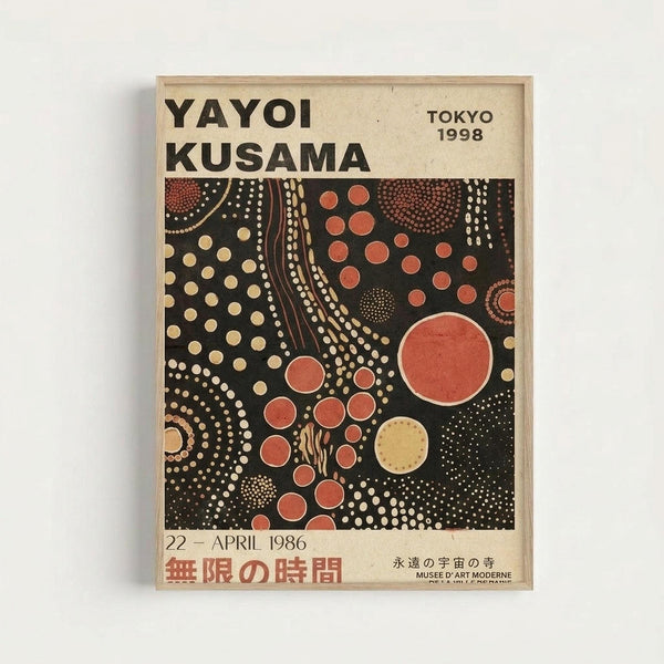 Framed exhibition poster featuring Yayoi Kusama's signature polka dot artwork on black background with red, yellow, and cream colored circles in various sizes. The poster displays "YAYOI KUSAMA" and "TOKYO 1998" at the top, with "22 - APRIL 1986" and Japanese text at the bottom. The artwork shows flowing dotted patterns and circular motifs characteristic of Kusama's infinity room installations. Natural wood frame against white wall.