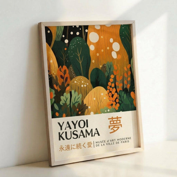 May include: Framed art poster leaning against white wall featuring abstract forest scene with green trees, orange and yellow foliage, white polka dots throughout, and mushroom shapes. White border contains "YAYOI KUSAMA" text with Japanese characters and "MUSÉE D'ART MODERNE DE LA VILLE DE PARIS" below. Natural wood frame visible around edges.