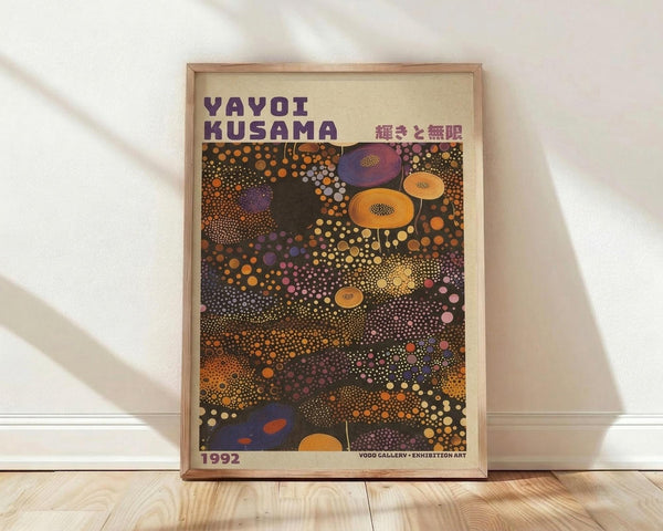 May include: Framed poster with abstract polka dot artwork in vibrant colors including orange, purple, yellow, and pink circles of varying sizes scattered across a dark background. The wooden frame sits against white walls on light wood flooring with natural sunlight casting diagonal shadows across the scene.