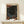 May include: Framed poster with cosmic artwork featuring swirling dark space filled with colorful dots and circles in orange, red, and blue tones. White moon or planet visible in center against starry black background. Flowing abstract forms create movement around the edges. Japanese text visible at top. Natural wood frame sits on light wooden surface with small white wrapped gift box beside it. Clean white wall background creates minimalist display setting.