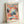 May include: Framed art print in light wood frame leaning against white wall. Poster features abstract artwork with colorful dot patterns in coral, turquoise, navy and cream tones, resembling organic cellular forms. Text at top reads "YAYOI KUSAMA" with Japanese characters at bottom and small Museum of Modern Art New York text. Vibrant contemporary art style with flowing, bubble-like textures throughout composition.
