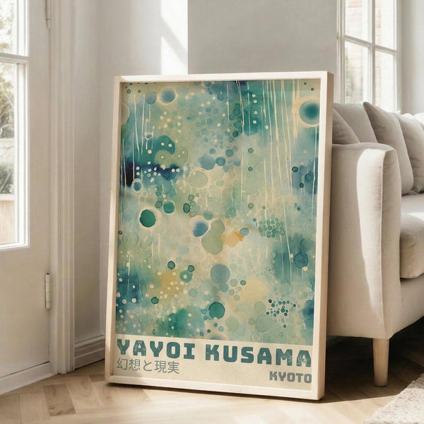 May include: Framed poster with abstract artwork featuring turquoise and teal circles, dots, and dripping paint effects on cream background, displayed against white wall next to beige sofa in bright living room with large windows and natural lighting