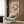 May include: Colorful abstract art poster with dotted patterns in coral, blue, and cream tones displayed in modern living room with beige armchair, brass floor lamp, and wood panel wall. Framed artwork features flowing organic shapes and polka dot motifs in Japanese-inspired style.