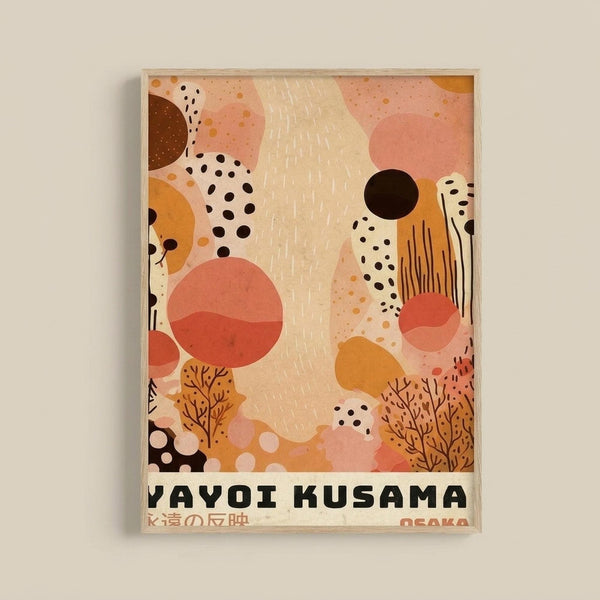 Framed abstract art print featuring warm coral pink, orange, cream and black organic shapes, polka dots, and tree-like patterns in a modern minimalist style. The artwork includes flowing forms, scattered circles, vertical line textures, and botanical silhouettes. Text at bottom reads "YAYOI KUSAMA" with Japanese characters and "OSAKA". Light wood frame displayed against cream colored wall.