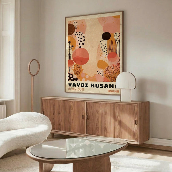May include: Abstract art poster with warm coral, orange and cream organic shapes, black dots and botanical elements, displayed above a mid-century wooden credenza in a minimalist living room with white curved chair and glass coffee table